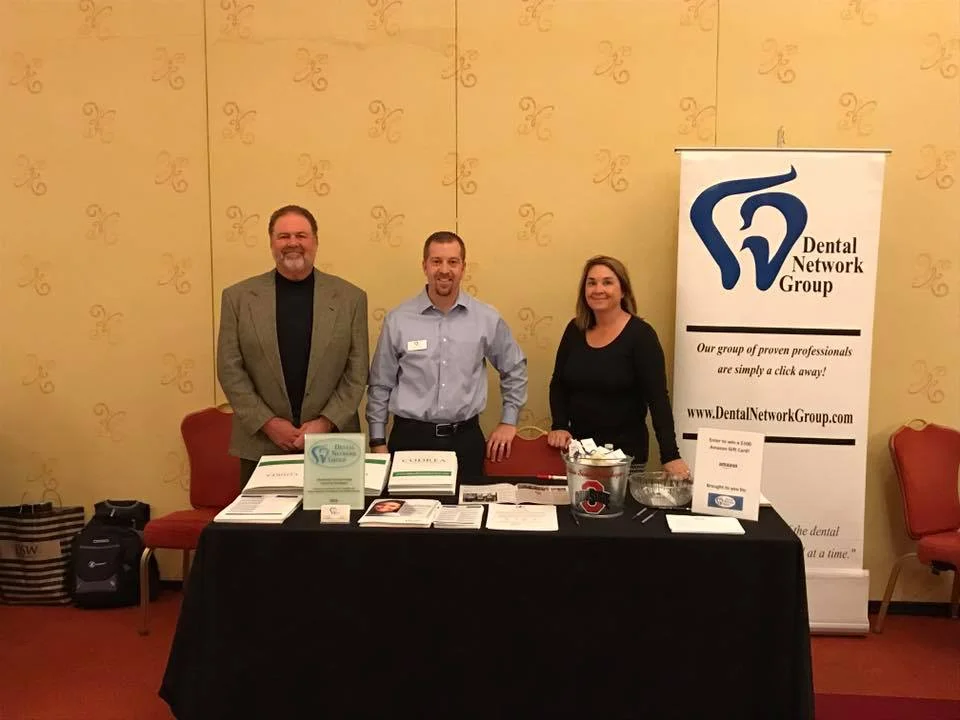 Dental Network Group members and dental professionals around a conference table